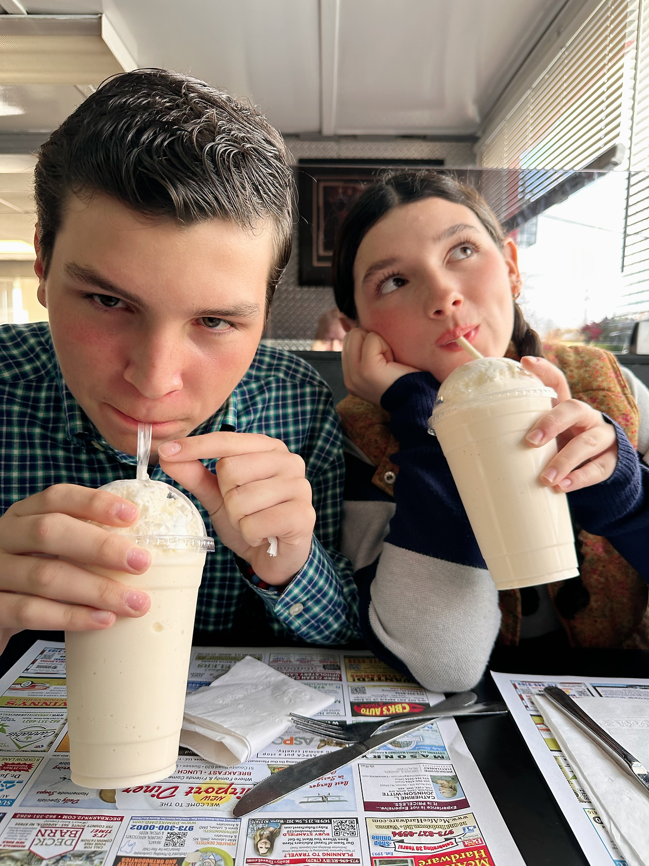 Gardener Anna and Gardener Aidan enjoying milkshakes at the Airport Diner after their You Are a Gardener® SEL Assembly presentation.