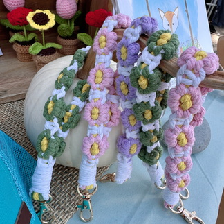 Close-up of handmade macramé flower keychains and crocheted flower décor at the You Are a Gardener® booth during Bottle Hill Day.