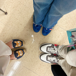 Gardener Shanna, Anna and Aidan standing side by side at Clifton E. Lawrence School, featuring Shanna’s signature fox shoes