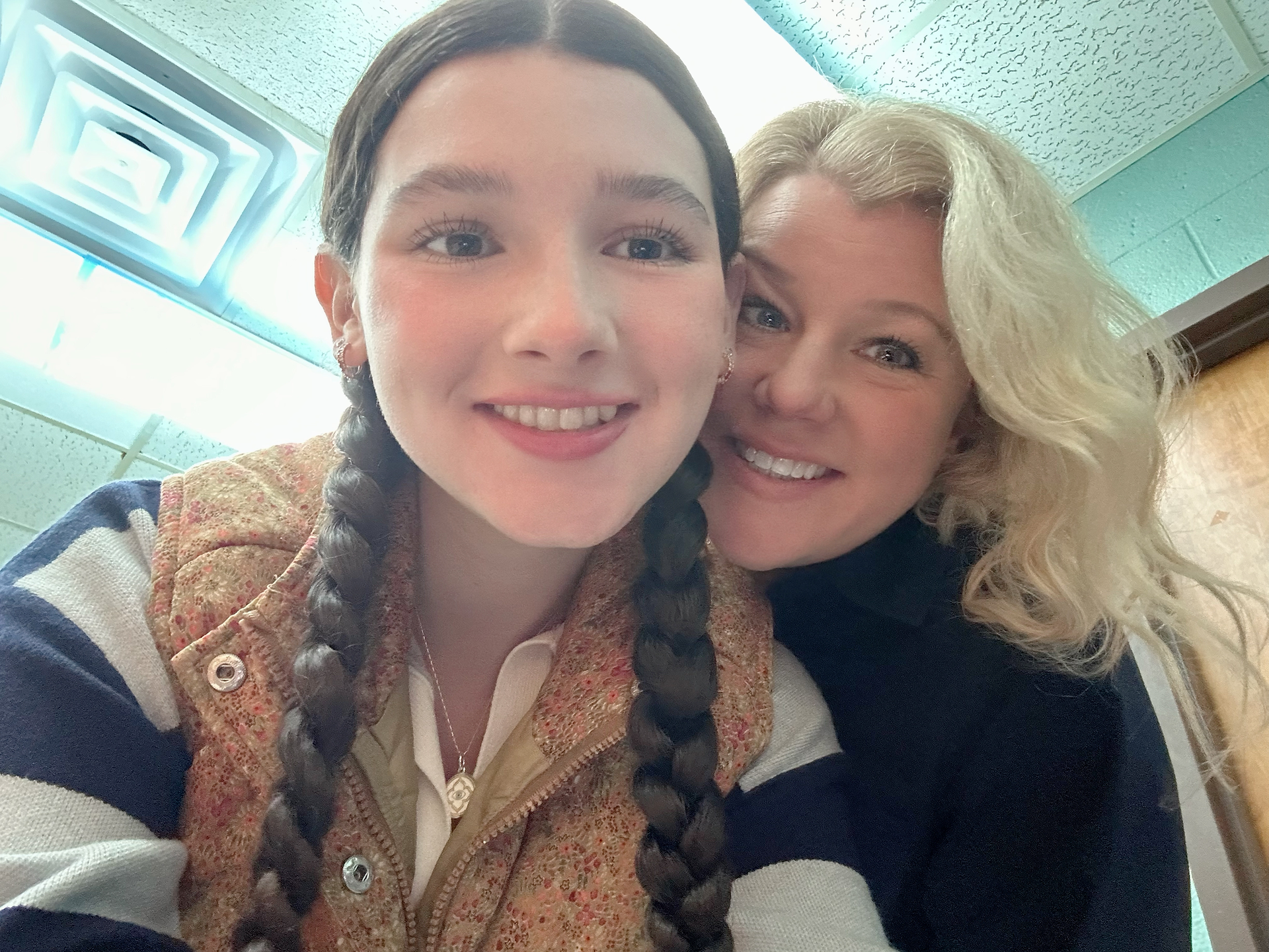 Gardener Shanna and Gardener Anna smiling together before their SEL assembly presentation.