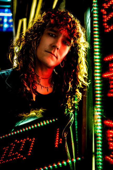 Cinematic portrait of Zach from Tailgunner in neon light with an editorial blur effect