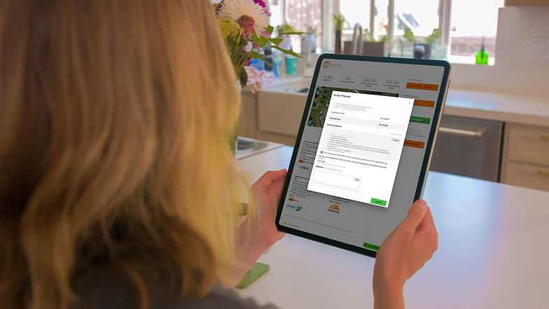 Solar PV system customer is holding a tablet that is reviewing the proposal details on OpenSolar