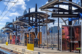 Light Rail station on the blue line located right across the street from 300 Optimist Park apartments. Image shows covered sections for people to stand under in inclement weather. 