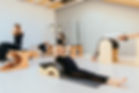 Fitness, sport, training and people concept - group of five people doing pilates exercises
