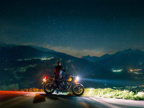 Rider sitting on a motorcycle on a street at night