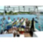 Offshore fishing charter boat with anglers reeling in fish in the blue waters near St Thomas US Virgin Islands