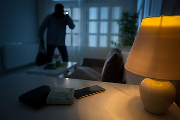 Burglar breaking into a home