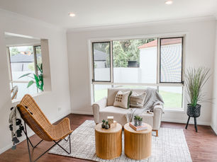 A styled lounge room surrounded by windows