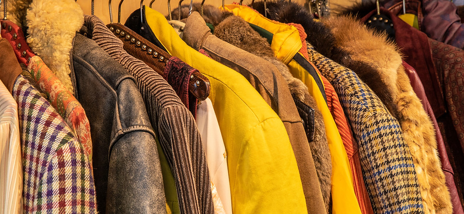 Sideview of colorful yellow and brown tinted vintage clothes, jackets with different patte