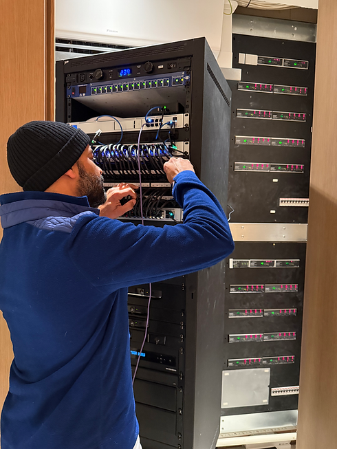Paul Mcken of Electric Frog Home Automation Specialist, London, working on the data network rack