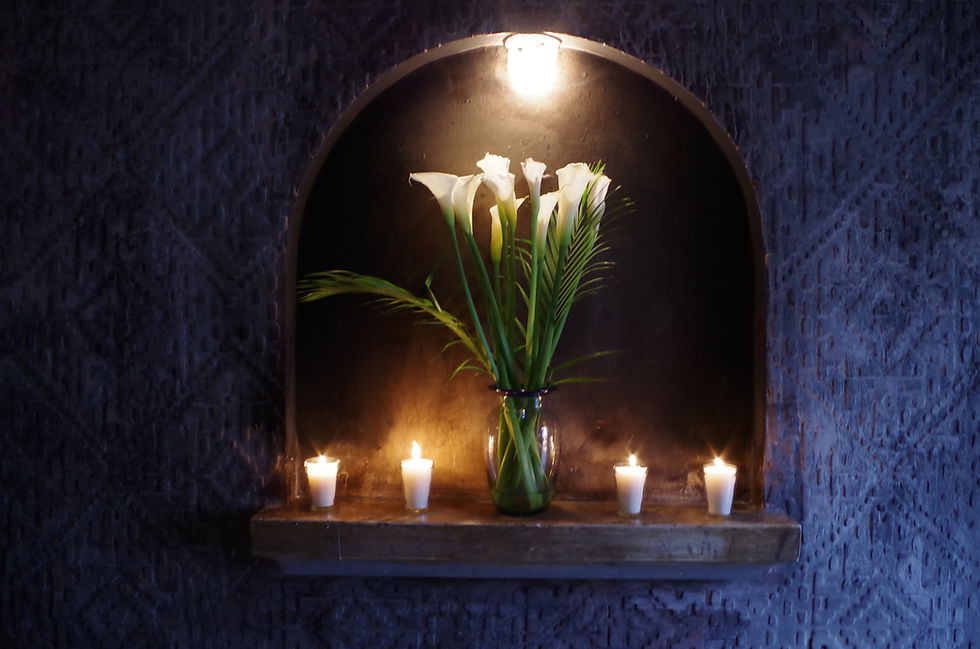 Elegant stone archway with white calla lilies and candles at Mesón Panza Verde boutique hotel, Antigua Guatemala - romantic colonial architecture details