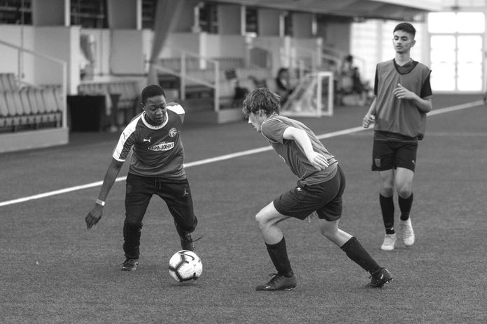 Youth soccer players practice, intense match