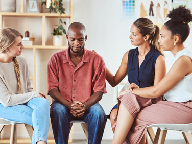 A group of diverse people have a group therapy session