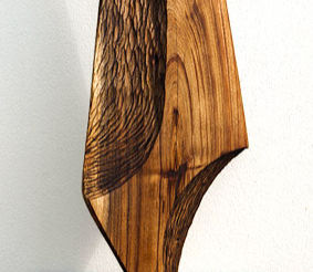 Balanced and elegant carved tabletop sculpture in Australian hardwood. NZ small wood sculptures. Cropped.