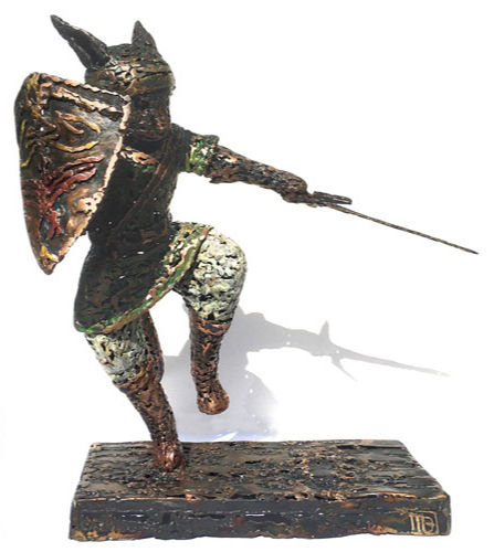 Thumbnail: Welded bronze sculpture of a cat in green top, white pants, with a sword in a guard position and a shield. Side shot.