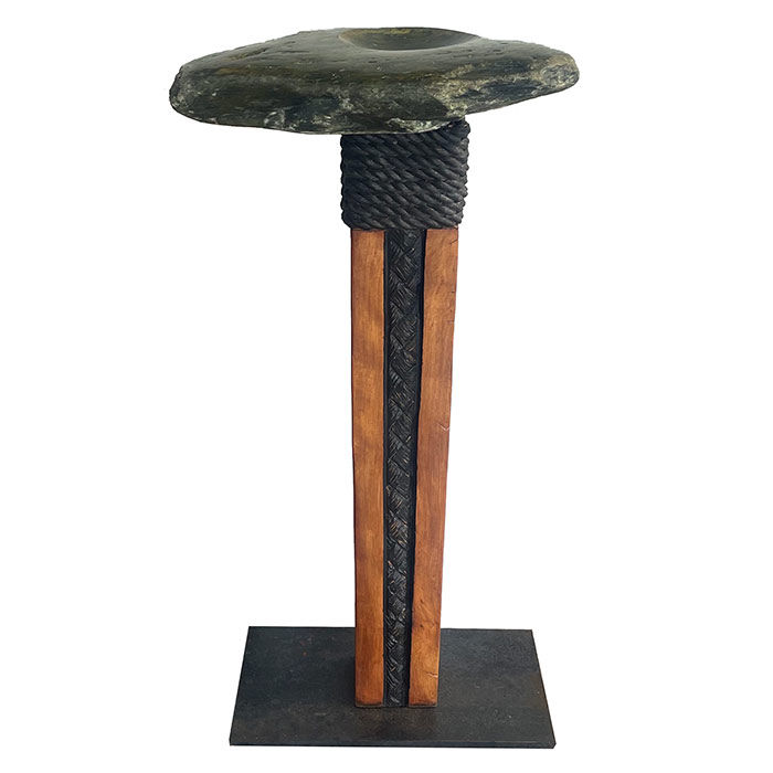 Maori stone carving of a pounamu touchstone or bowl mounted on a kauri wood post with black rope binding. NZ art.