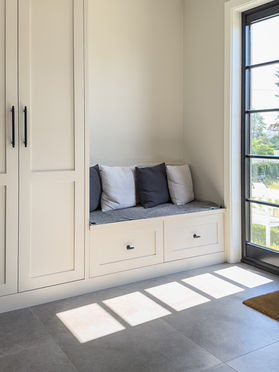 En sittebenk praktisk plassert rett ved inngangsdøren (manglende sittepute på mål etterleveres)