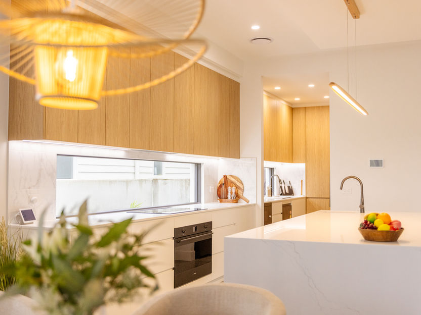 Residential electrical installation of pendant lighting and power points in a modern kitchen design.