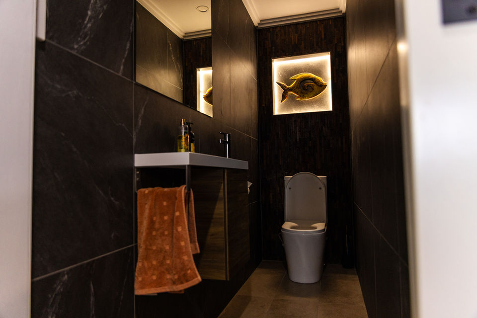 Designer bathroom vanity lighting and power outlet installation in a luxury home.