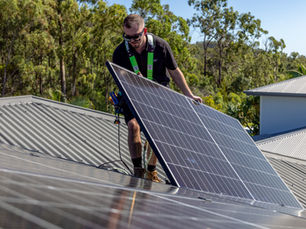 Nergy electrician installing residential solar panels on a metal roof in Southeast Queensland