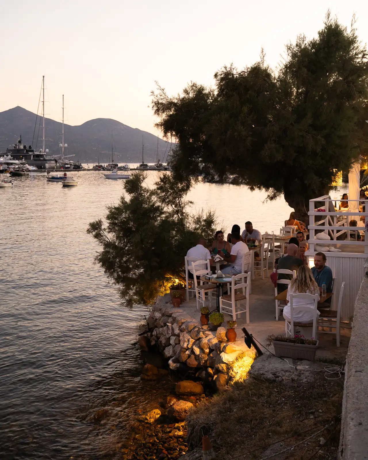 Beautiful waterfront restaurants at night in Adamantas, Milos - Greece