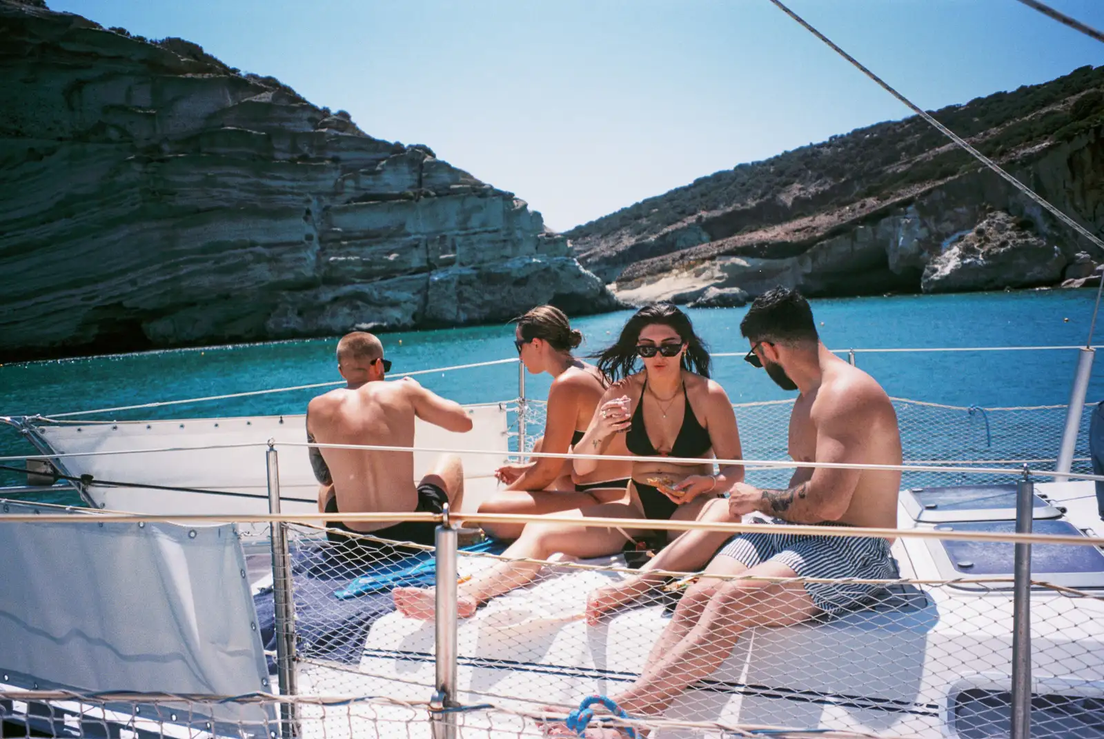 travellers on a yacht at Kalogries beach- Milos island, greece