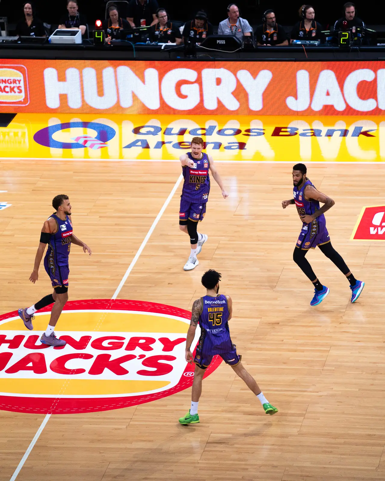 birds-eye sports photography of sydney kings nbl basketball players- angus glover, dj hogg and denzel valentine 