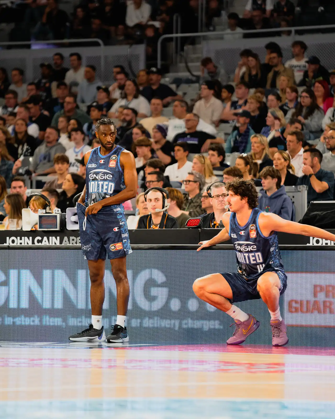 melbourne united players ian clark and kyle bowen subbing on at the bench