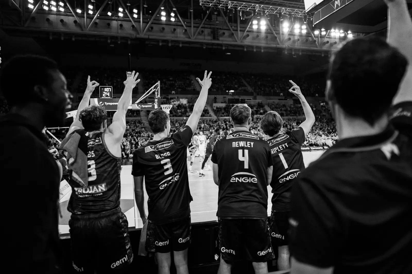 melbourne united nbl team on the bench celebrating