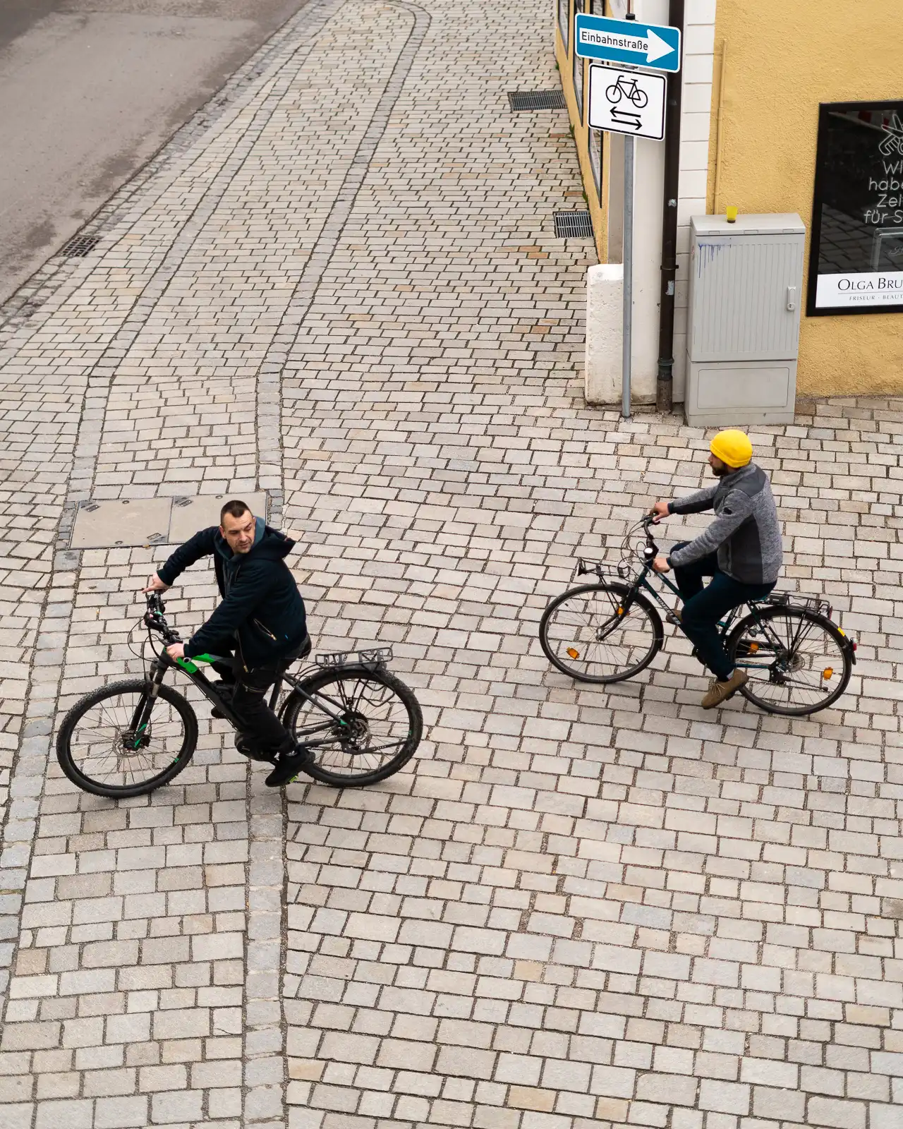 Two men riding their bike in Nördlingen, Germany