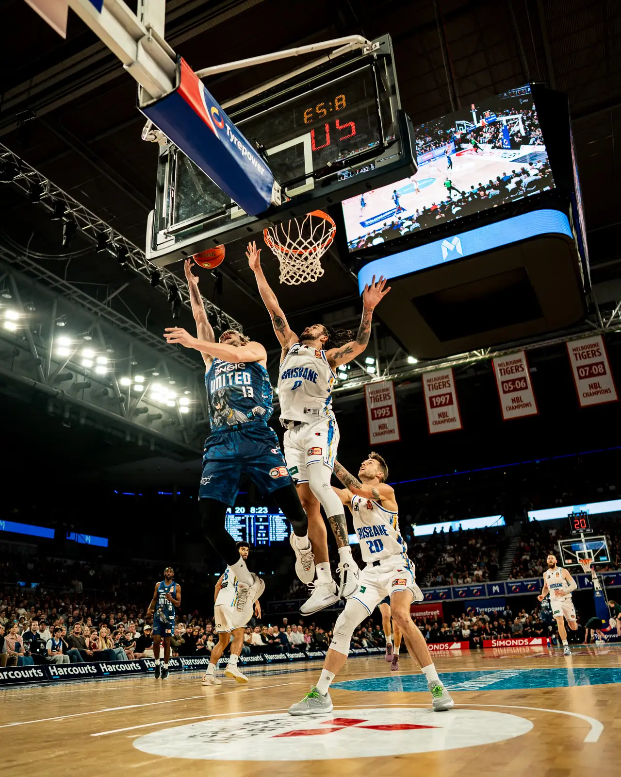 action shot of a layup during the nbl game melbourne united vs brisbane bullets