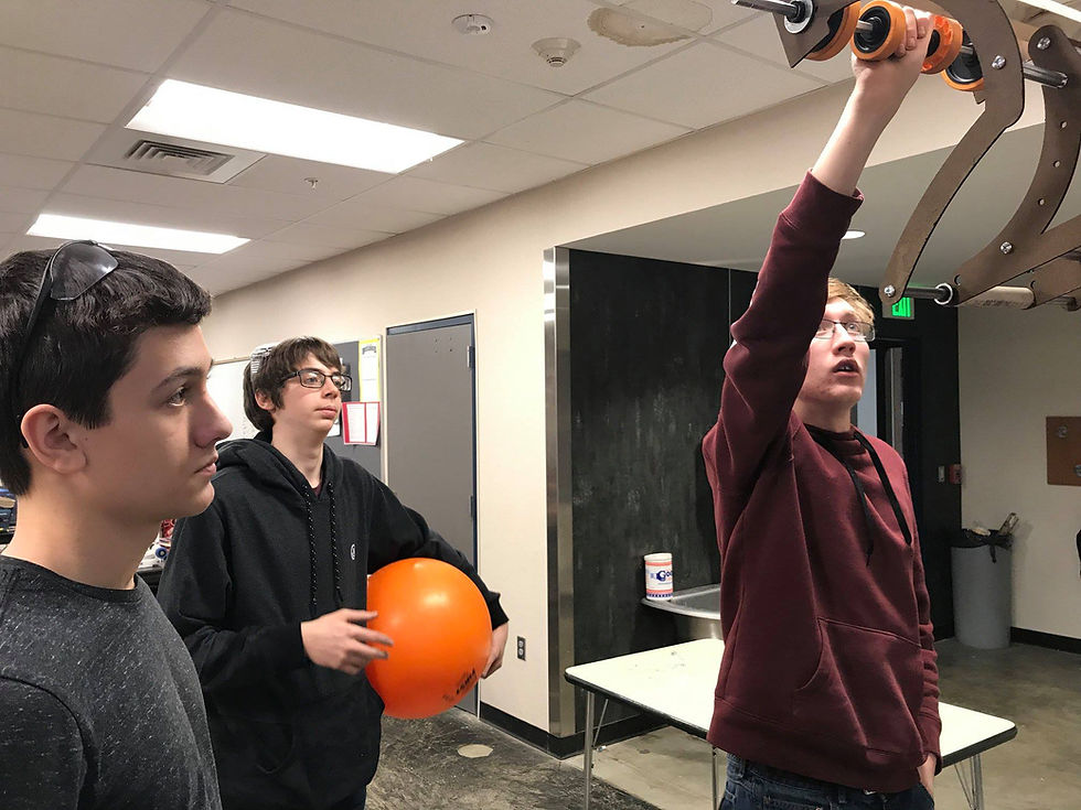 Tristan, Braylen and Jordan getting a better view of their intake prototype