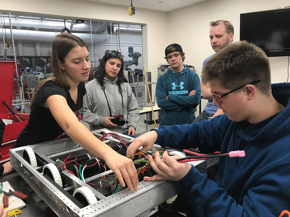 Jess, Hunter and Mentor Caleb discussing with to Omak Mentor Ricky and one of her students.