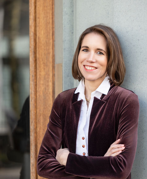 Brunette woman wearing a brown jacket posing during a portrait photography session