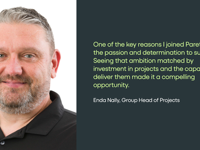 Portrait of a smiling man in a black polo beside a dark teal quote panel with lime text naming Enda Nally, Group Head of Projects.