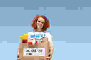 woman-holding-box-with-a-volunteer-t-shirt