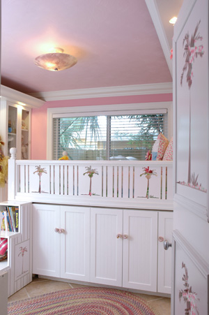 Bed elevated over cabinety for increased storage below