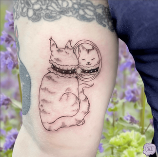 tattoo of a cat looking into a mirror