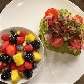 bowl of fresh fruit and a salad from saffron the eatery