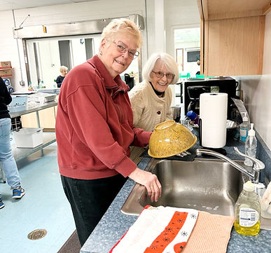 Two people serve with community presbyterian church