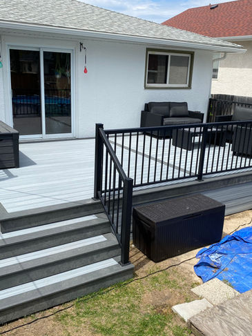 Light grey composite deck with railing.