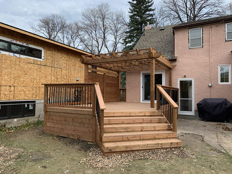 Wood deck with steps and pergola. 