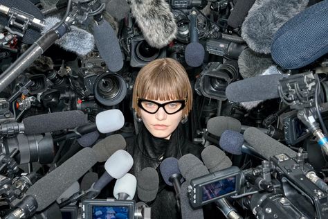 model surrounded by mics