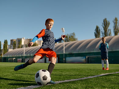 boy-playing-football-on-field-and-kicking-soccer-b-2023-01-07-02-21-28-utc (Large).jpg