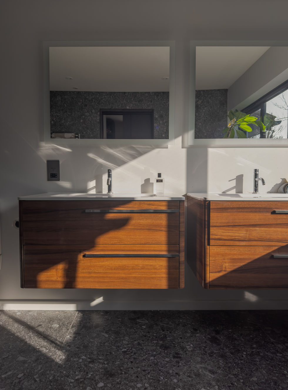 view of wall mounted vanity units and mirrors above