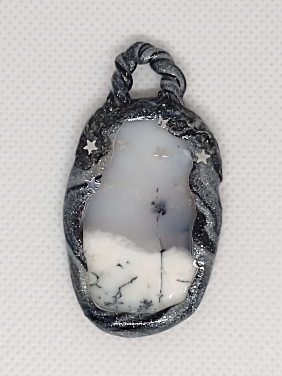 Thumbnail: This beautiful gemstone with its forest like appearance and its polymer ribbon setting