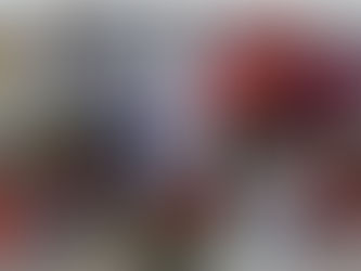 Flowers, candles, and photos of a religious figure create a vibrant memorial on a stone surface, conveying a solemn and respectful mood.