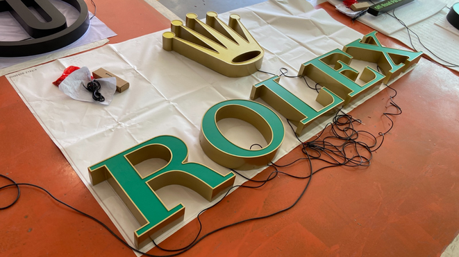 Gold stainless steel 3D letters with crown logo — premium fabricated signage