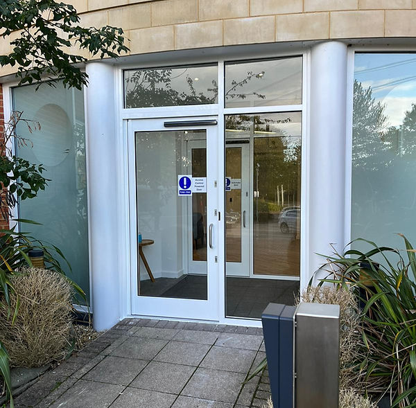 White, automatic commercial aluminium door and fixed side light window fitted to an Office in Whitely, Southampton, Hampshire.jpg