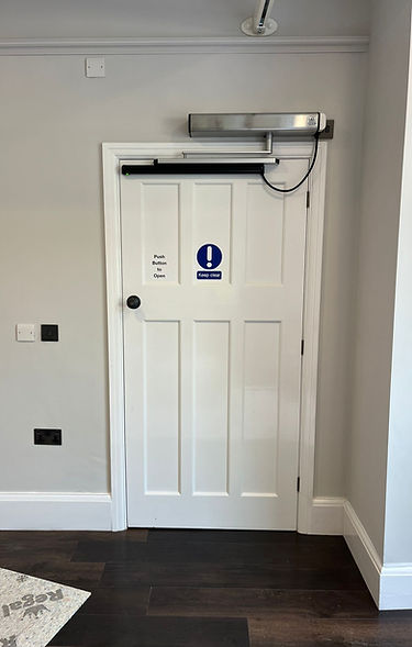 Record DFA 127 automatic swing door operator fitted to a wooden internal door for a disabled wheelchair user.jpg